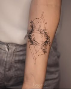 a woman's arm with a tattoo design on the left side of her arm