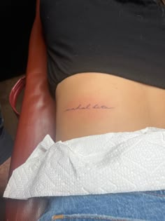 a woman's stomach with the word made in cursive writing on it