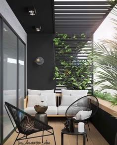 an outdoor living area with black walls and white furniture, plants on the balcony wall