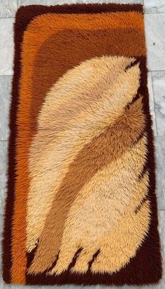 a brown and tan area rug sitting on top of a tile floor