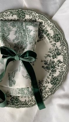 a green and white plate with a bow on it