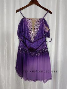 a purple dress hanging on a white curtain