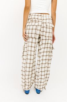 the relaxed plaid pants that aesthetic outfit ideas are made of. these cargo pants-inspired bottoms feature a drawstring waist, pouch pockets, + trendy ties at the ankles. the perfect straight leg pants to wear with your favorite pair of flats, sneakers, or boots. taupe plaid // straight leg, elastic drawstring waistband, pockets, adjustable tie at hem paired with our lotus top model is 5'10" + wearing a small measurements are approximate + taken while laying flat small : waist 26” inseam 28” le Affordable Plaid Bottoms For Vacation, Plaid Slant Pocket Pants, Cheap Plaid Cotton Pants, Summer Autumn Outfit, Aesthetic Outfit Ideas, Waist Pouch, Pants Large, Aesthetic Outfit, Plaid Pants