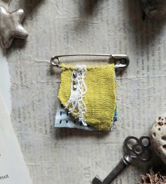 a small yellow and white purse sitting on top of a table next to a pair of scissors