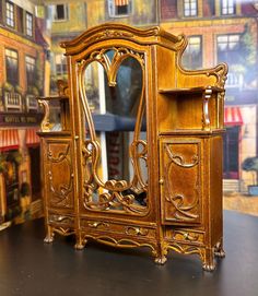 an ornately carved wooden dresser and mirror