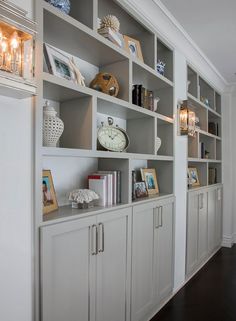 a white bookcase filled with lots of books