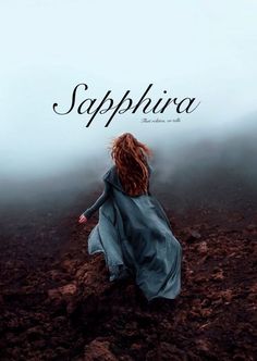 a woman in a blue dress walking across a dirt field with the words saphirra above her