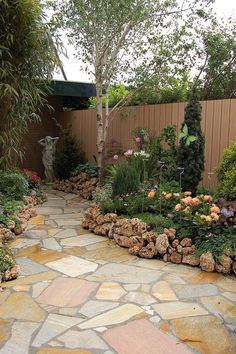 a stone path in the middle of a garden