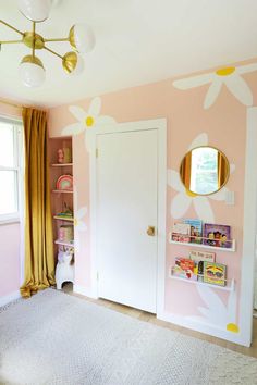 a bedroom with pink walls and yellow curtains