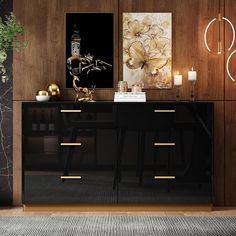 a black and gold sideboard in a living room with two candles on the table