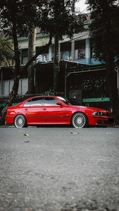 a red car parked in front of a building