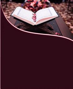 an open book sitting on top of a table in front of a group of people