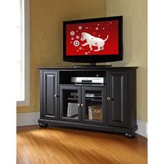 a flat screen tv sitting on top of a black entertainment center