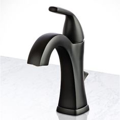 a black faucet sitting on top of a white counter