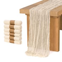 a wooden bench with four rolls of white yarn on the bottom and one roll of brown