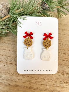 the cookie jar earrings are decorated with red bows