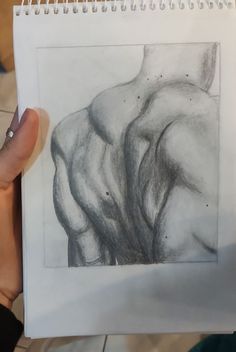 a person holding up a drawing of a man's torso