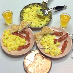 three plates with breakfast foods on them next to a penny