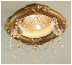 an ornately decorated ceiling fixture with crystal drops