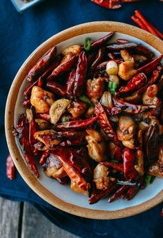 a bowl filled with red peppers and other food items