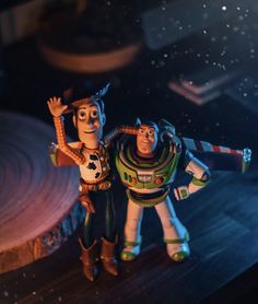 two toy story characters standing next to each other