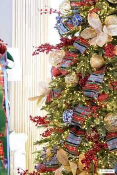 a decorated christmas tree with red, white and blue ornaments