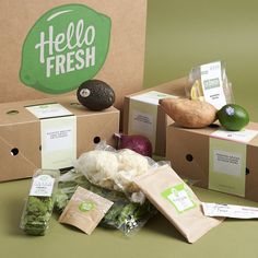 an assortment of fresh produce is displayed in front of two boxes with the words hello fresh on them