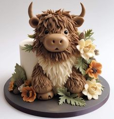 there is a cake decorated like a cow with flowers on it's head and horns