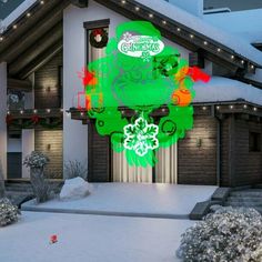 an animated christmas display in front of a house with snow on the ground and decorations