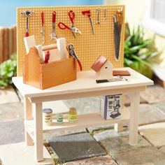 a miniature table with tools and scissors on it