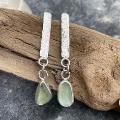 The sea glass used in these earrings were found on the Big Island of Hawaii. As you can see, no two pieces of sea glass are the same. That is what makes these earrings so unique. Fine Silver and Sterling Silver was used to create these hand crafted pieces. Earring post with sterling silver ear nut. Photos are taken outside in sunlight and shaded areas to show the way the light shines differently on the sea glass. Handmade Sea Glass Dangle Earrings, Silver Smithing, Big Island Of Hawaii, Island Of Hawaii, Sea Glass Earrings, Earring Post, The Big Island, Portfolio Ideas, Green Sea