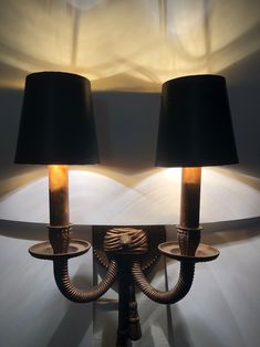 two lamps that are sitting on a wall