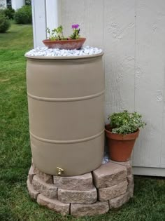 a water tank sitting next to a potted plant