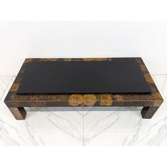 a wooden table sitting on top of a marble floor