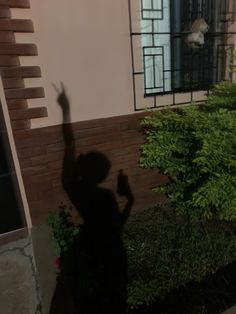 the shadow of a person standing in front of a window