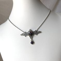 "This gothic vampire inspired necklace is made with an antiqued silver plated filigree bat and findings, accented with sparkling glass crystals in DEEP VIOLET PURPLE. Wingspan is 2 1/4\" wide and centerpiece is 1 1/2\" tall in the center. necklace isadjustable 15-18\" with a lobster clasp and chain extender in the back. If you would like a different length or stone color, please send us a message. Matching headpiece is available in our store." Silver Vampire Style Necklace, Gothic Halloween Costume Necklace, Gothic Nickel-free Necklace For Halloween, Gothic Nickel-free Necklaces For Halloween, Gothic Silver Necklace For Cosplay, Gothic Silver Jewelry For Cosplay, Silver Gothic Necklace For Cosplay, Silver Gothic Jewelry For Cosplay, Gothic Pendant Necklace For Halloween