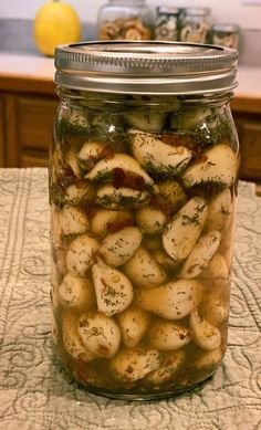 a jar filled with potatoes sitting on top of a table