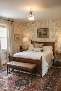 a bed sitting in a bedroom on top of a rug next to two tables and lamps