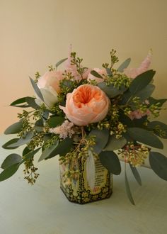 an arrangement of flowers in a vase on a table