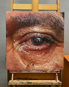 an easel with a painting on top of it that has been painted to look like an eye