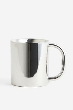 a stainless steel coffee mug with a black stripe on the outside and inside, against a white background