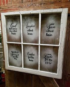 an old window with six different sayings on the glass and wood paneled wall