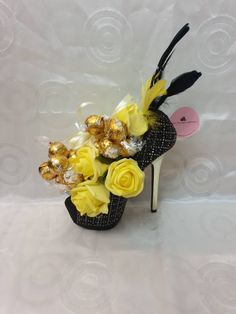 a shoe decorated with flowers and chocolates