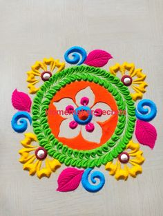 a colorful flower design on a white surface