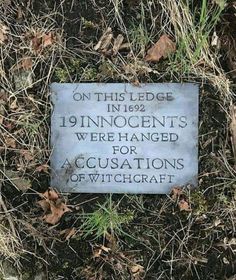 a plaque in the grass that says, on this ledge is 19 innocents were hanged for accusations of witchcraft