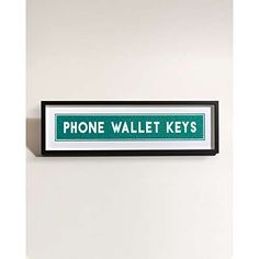 there is a phone wall key sign hanging on the wall