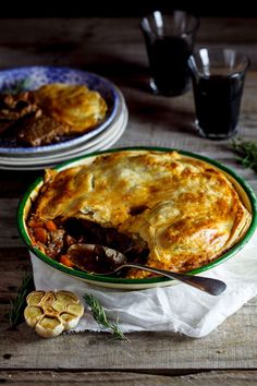 two plates with pies on them sitting on a table