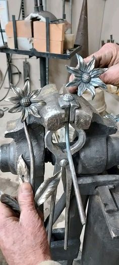 a man working on an object in a shop with metal parts and tools around him