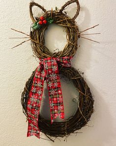 a cat shaped wreath hanging on the wall