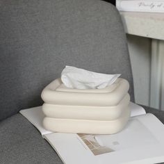 three inflatable mattresses sitting on top of an office chair next to a binder